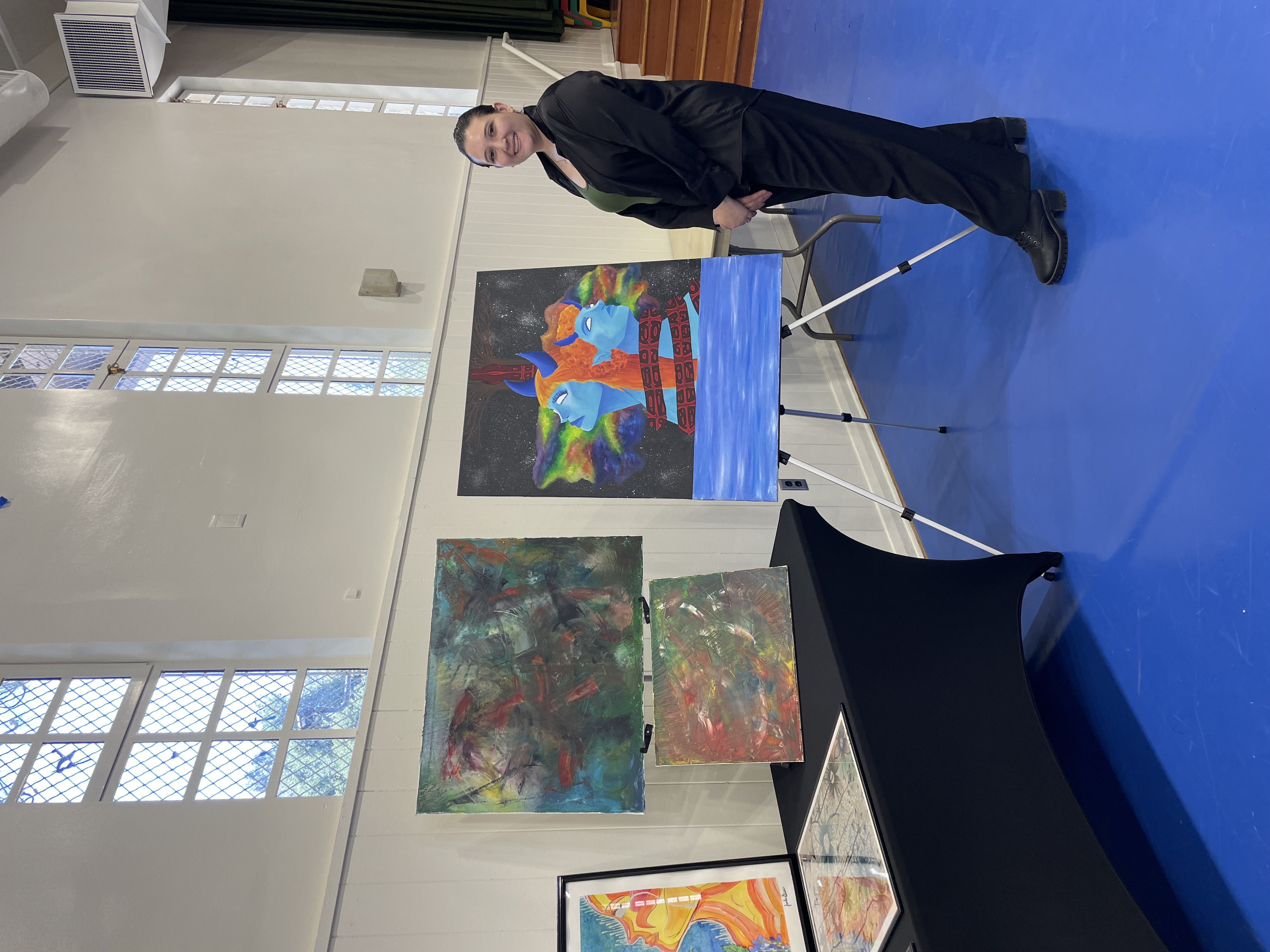 Artwork display and guests at Amor y Arte exhibition